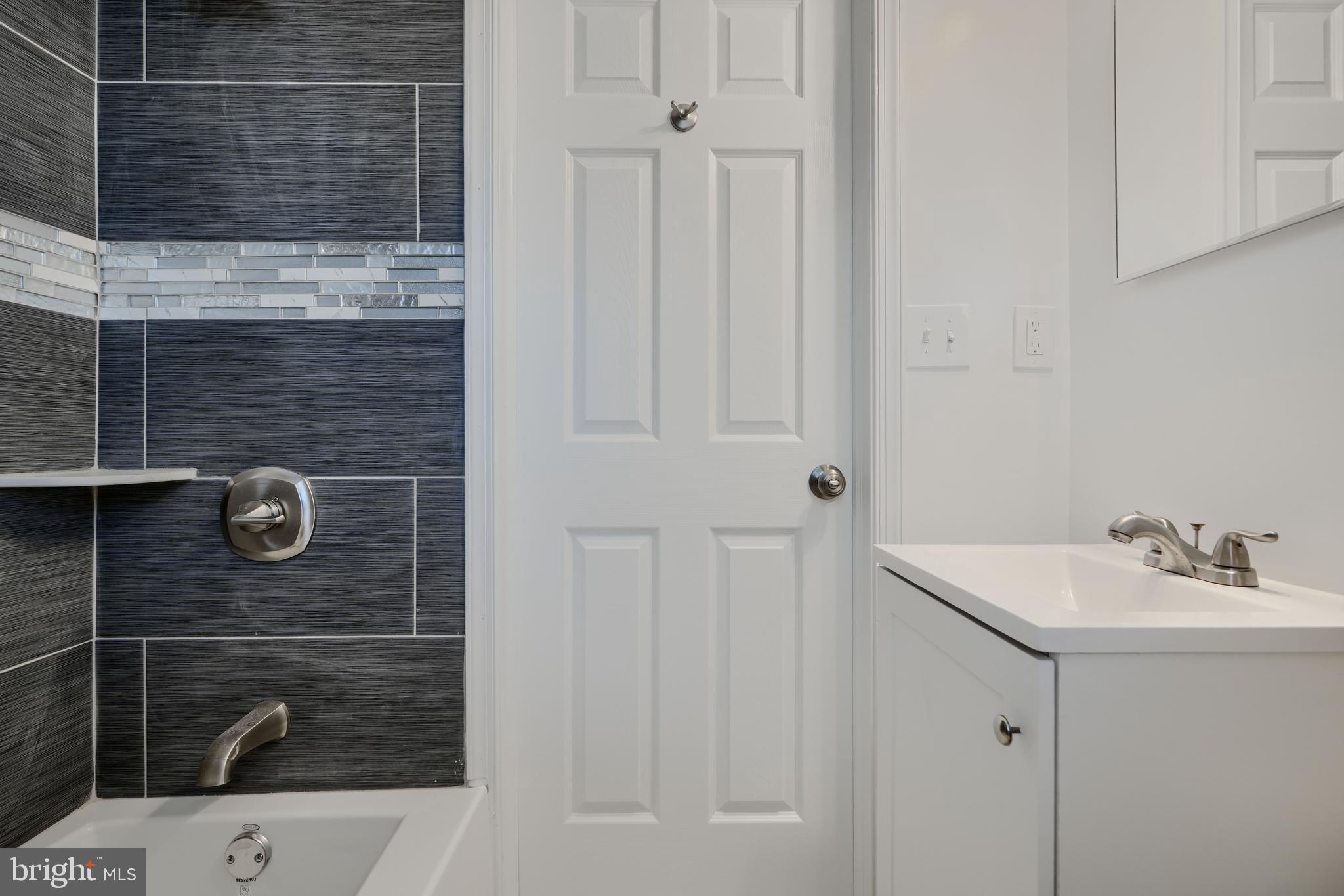 1632 Riverwood Road Baltimore, MD 21221 - Photo 15 of 32 a bathroom with a sink a toilet and shower