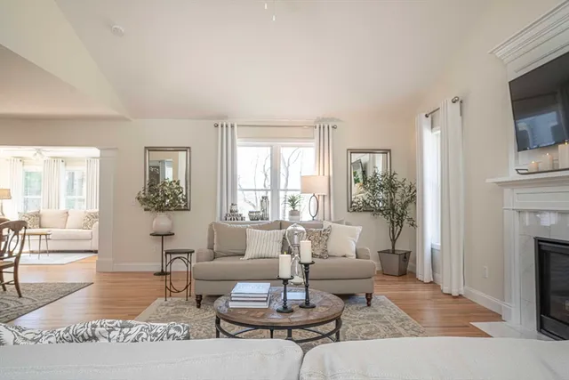 a living room with furniture a table and a fireplace