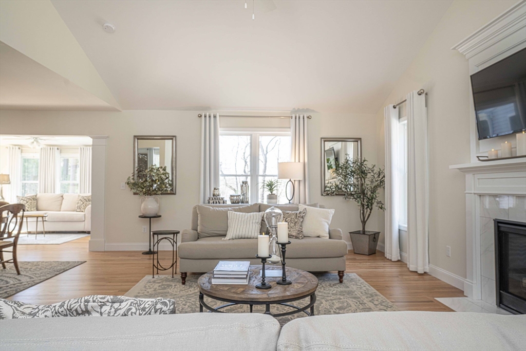 698 Pine Street Raynham, MA 02767 - Photo 15 of 21 a living room with furniture a table and a fireplace
