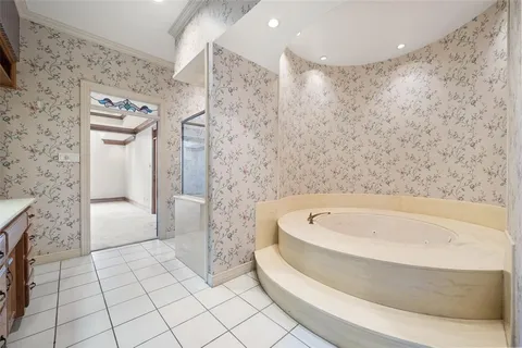 a spacious bathroom with a sink a mirror and a bathtub