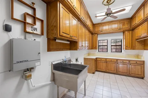 a bathroom with a tub a sink and mirror