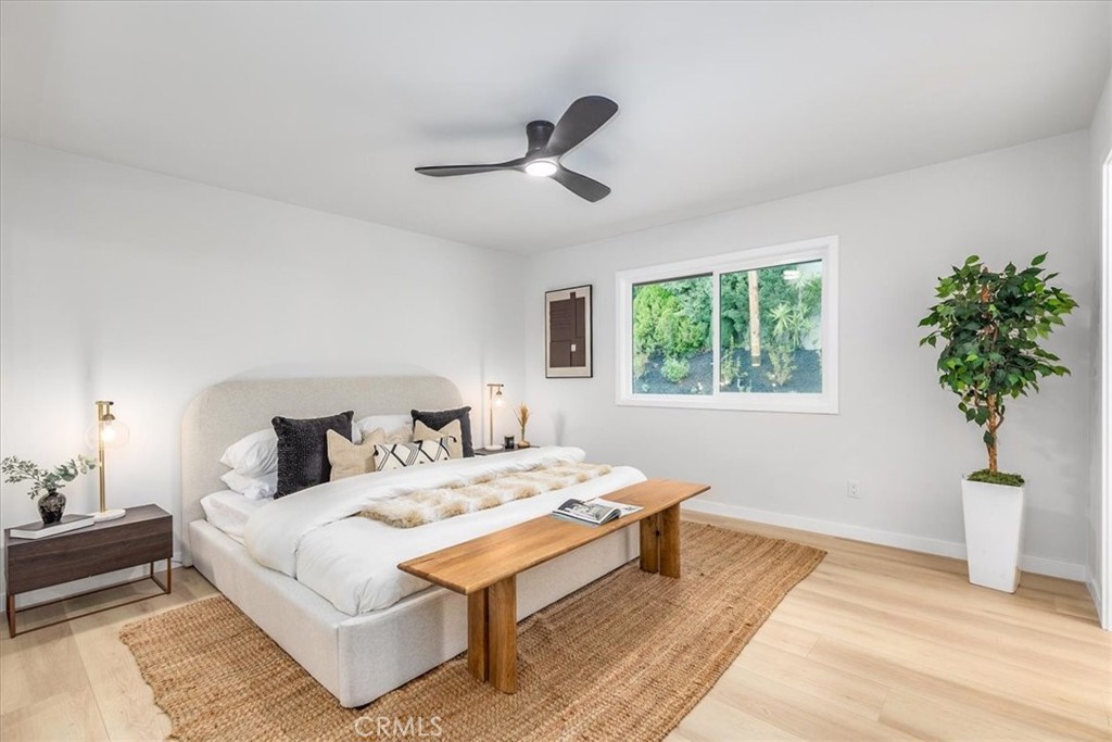 26005 Adamor Road Calabasas, CA 91302 - Photo 14 of 34 a bedroom with a bed and a potted plant