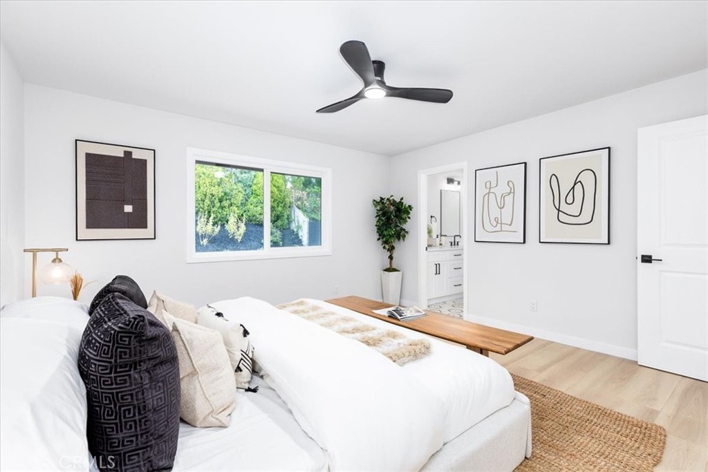26005 Adamor Road Calabasas, CA 91302 - Photo 16 of 34 a spacious bedroom with a large bed and a window