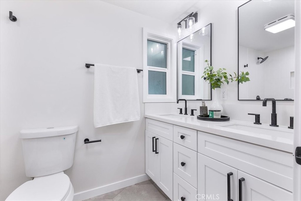 26005 Adamor Road Calabasas, CA 91302 - Photo 21 of 34 a bathroom with a granite countertop sink mirror and toilet
