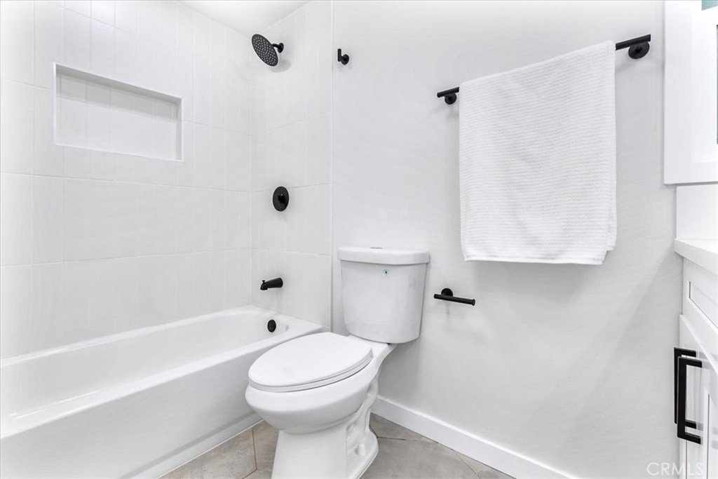 26005 Adamor Road Calabasas, CA 91302 - Photo 22 of 34 a bathroom with a toilet a sink a mirror and bathtub
