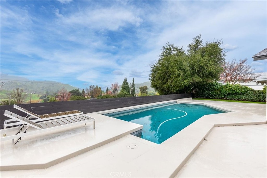 26005 Adamor Road Calabasas, CA 91302 - Photo 30 of 34 a view of a pool with a yard