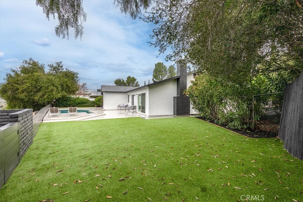 26005 Adamor Road Calabasas, CA 91302 - Photo 33 of 34 a view of a house with backyard and a tree