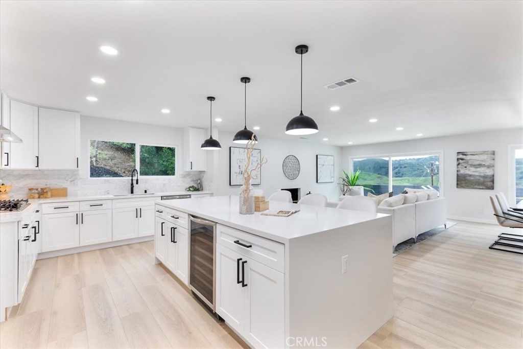 26005 Adamor Road Calabasas, CA 91302 - Photo 6 of 34 a large kitchen with kitchen island a sink stainless steel appliances and cabinets