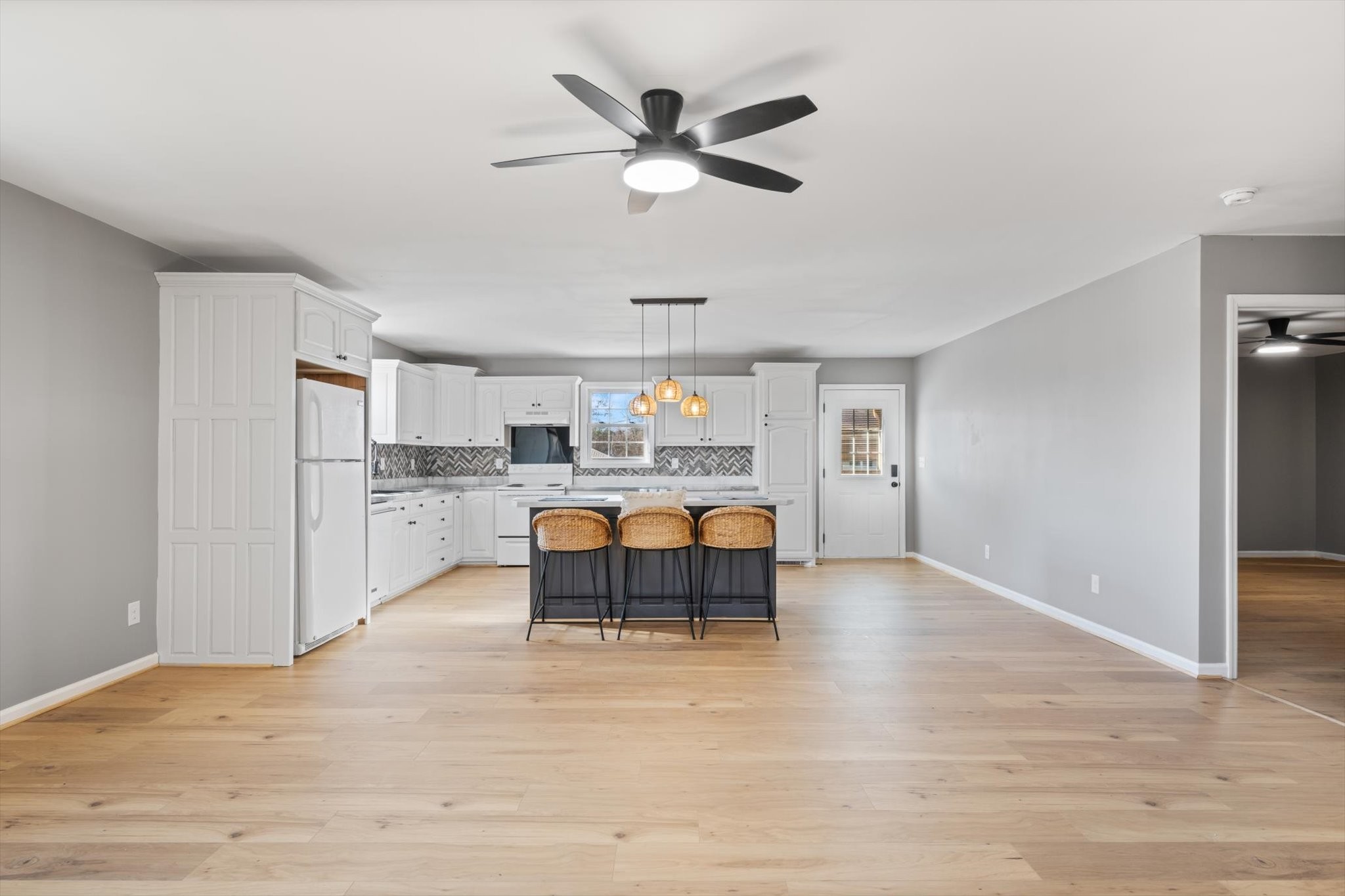 245 South Mill Street Linden, TN 37096 - Photo 2 of 30 a living room with kitchen island furniture and a ceiling fan