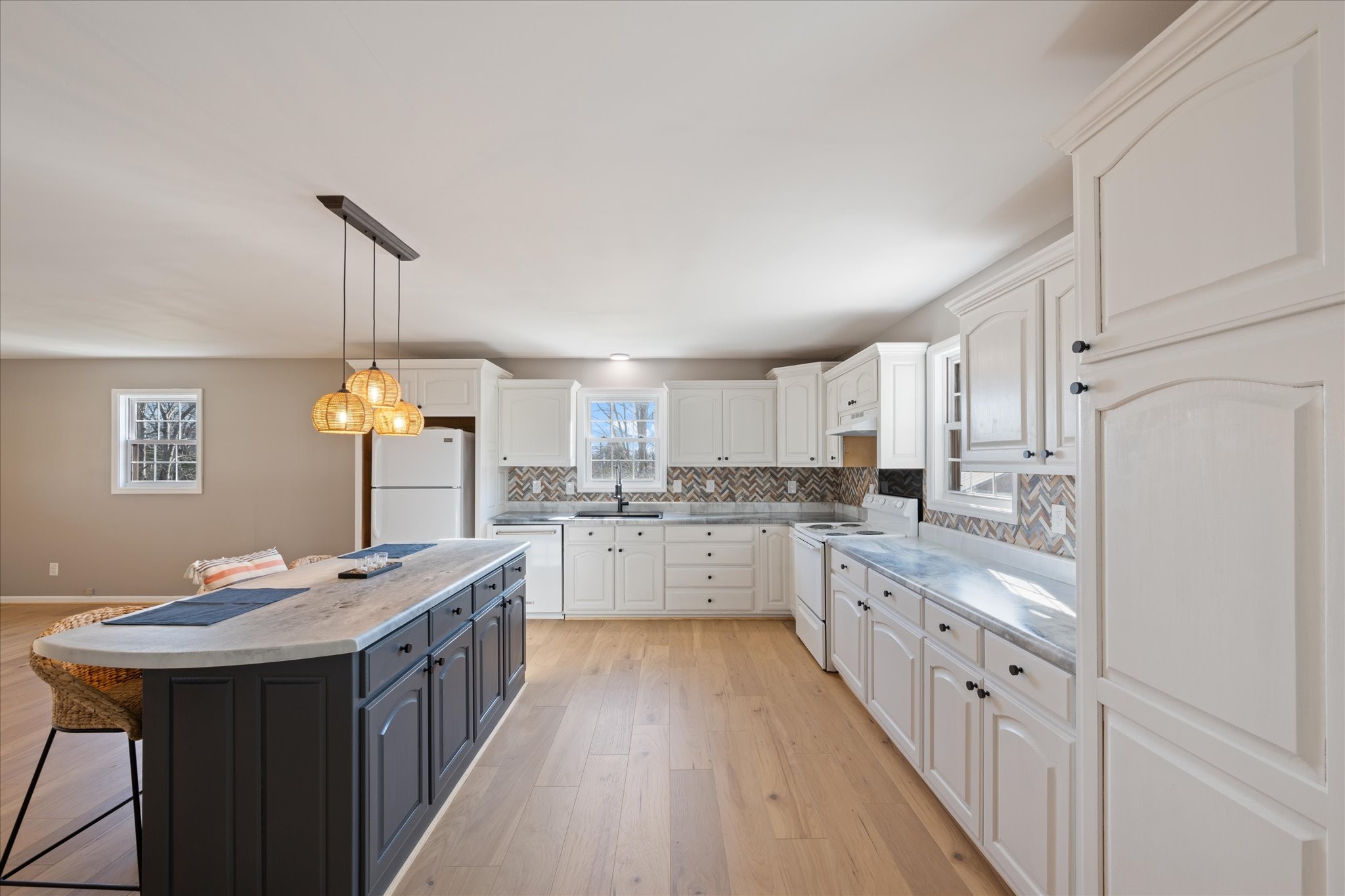 245 South Mill Street Linden, TN 37096 - Photo 8 of 30 a kitchen with granite countertop white cabinets sink and white appliances