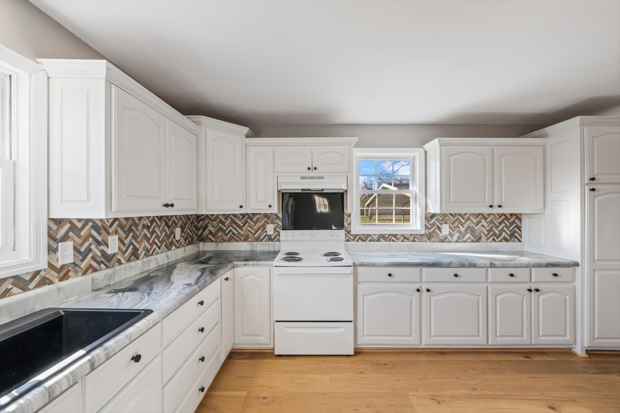 245 South Mill Street Linden, TN 37096 - Photo 10 of 30 a kitchen with granite countertop a sink and cabinets