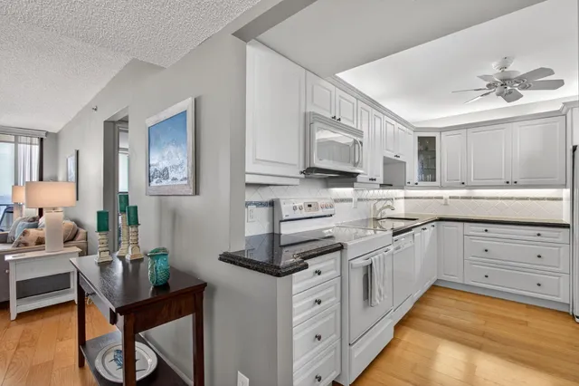 a kitchen with cabinets appliances and a counter space