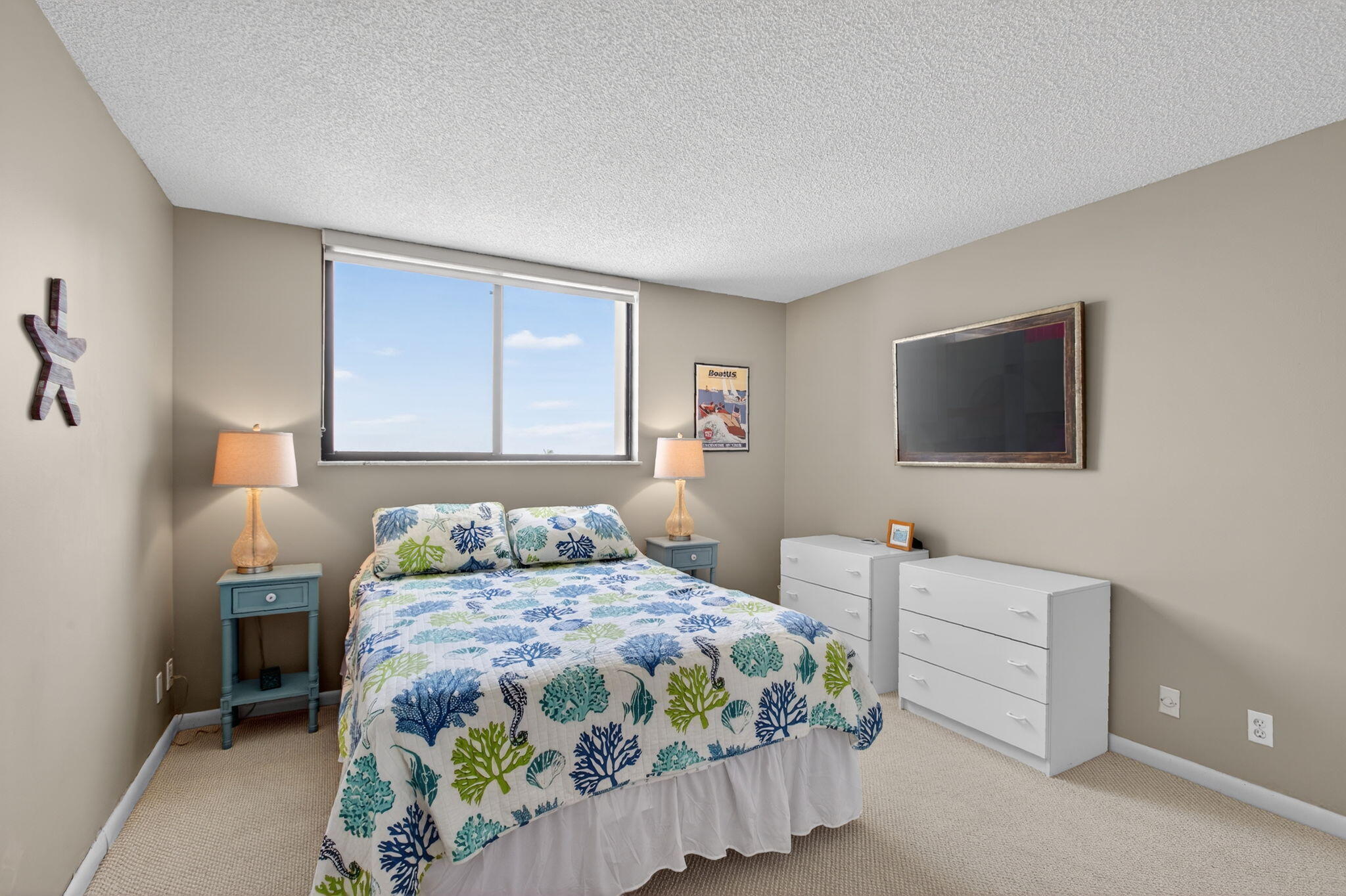 200 Ocean Trail Way, Unit 405 Jupiter, FL 33477 - Photo 18 of 46 a bedroom with a bed and a flat screen tv