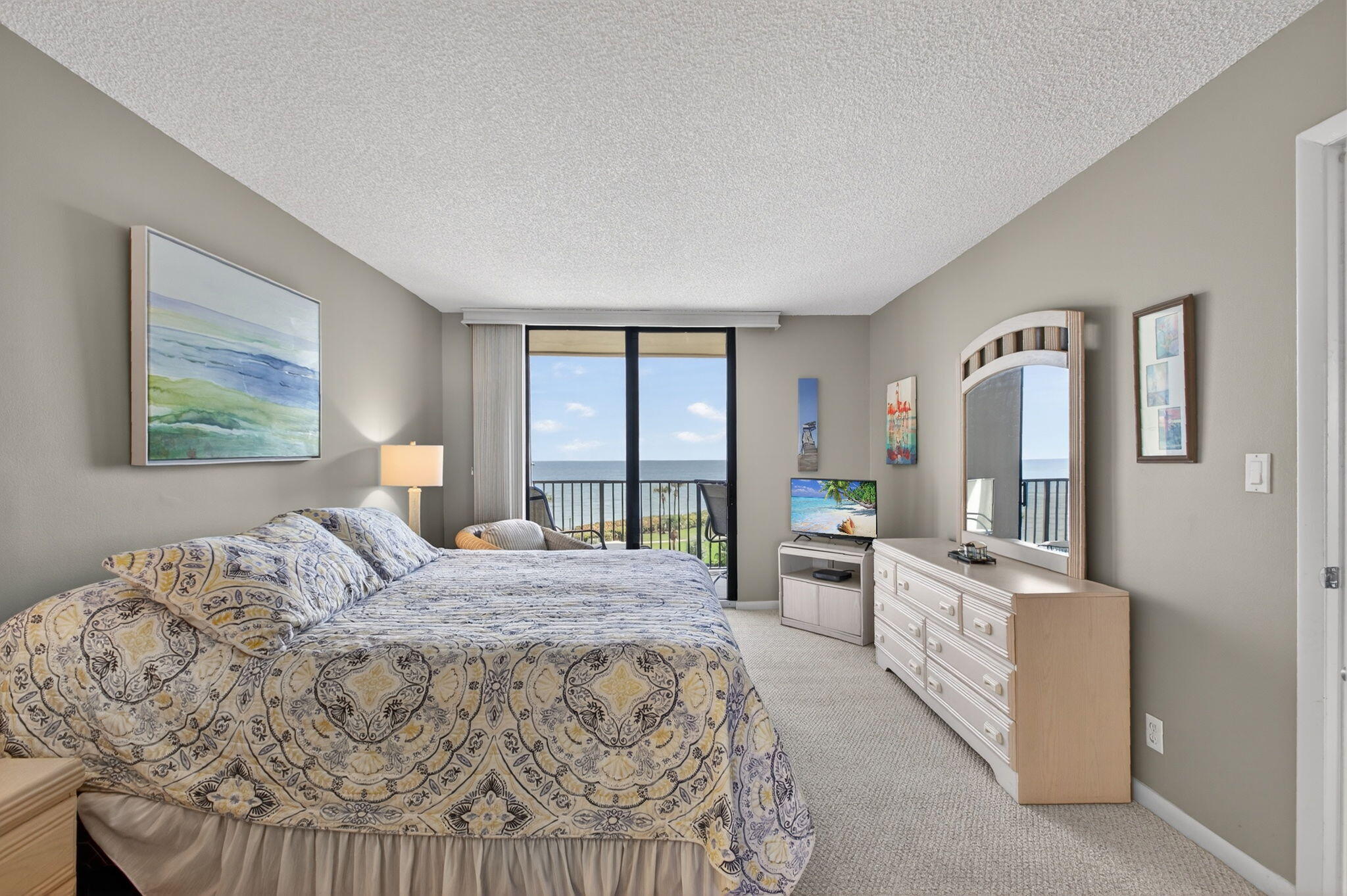 200 Ocean Trail Way, Unit 405 Jupiter, FL 33477 - Photo 25 of 46 a bedroom with a large bed and a balcony