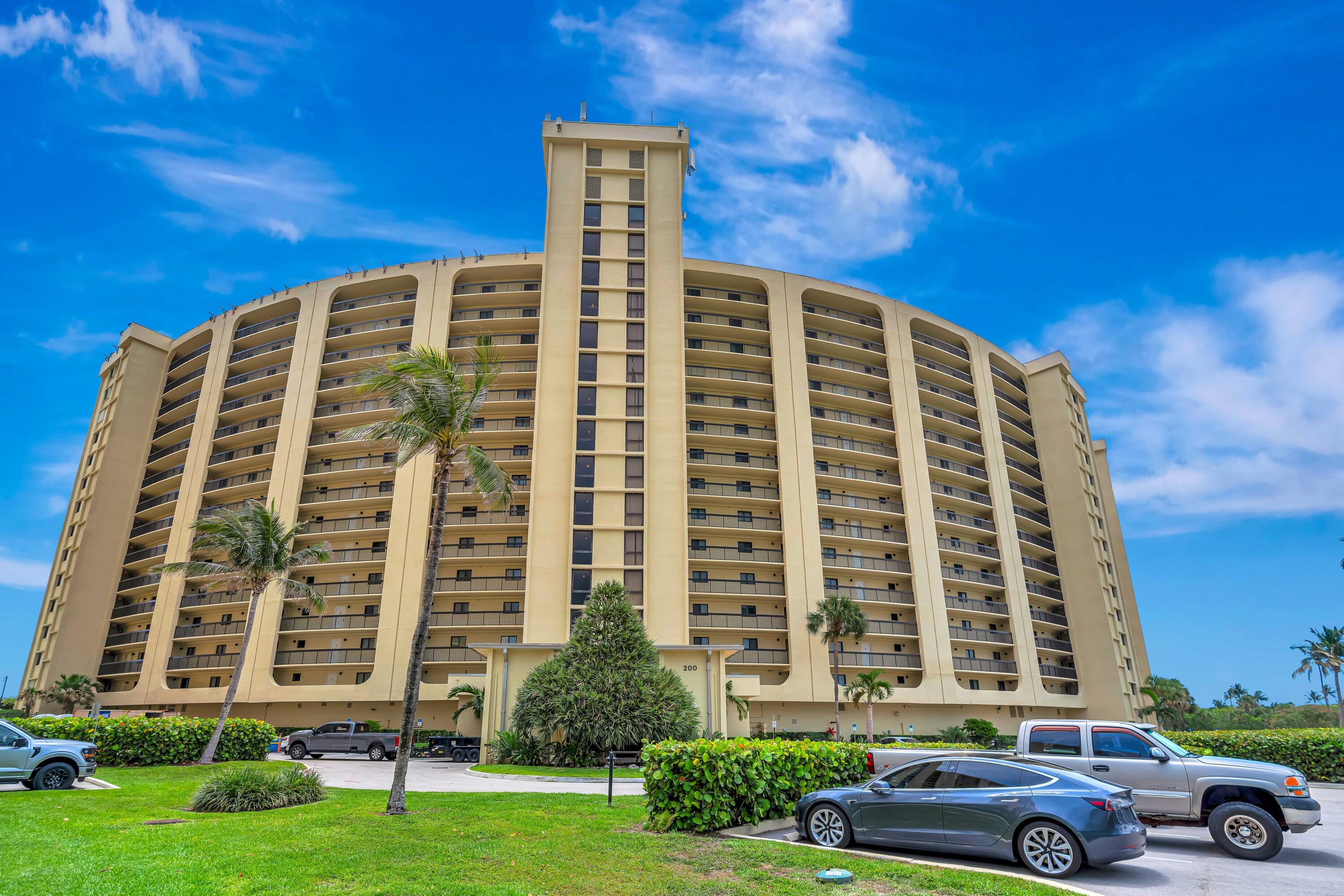 200 Ocean Trail Way, Unit 405 Jupiter, FL 33477 - Photo 39 of 46 front view of a building with a yard