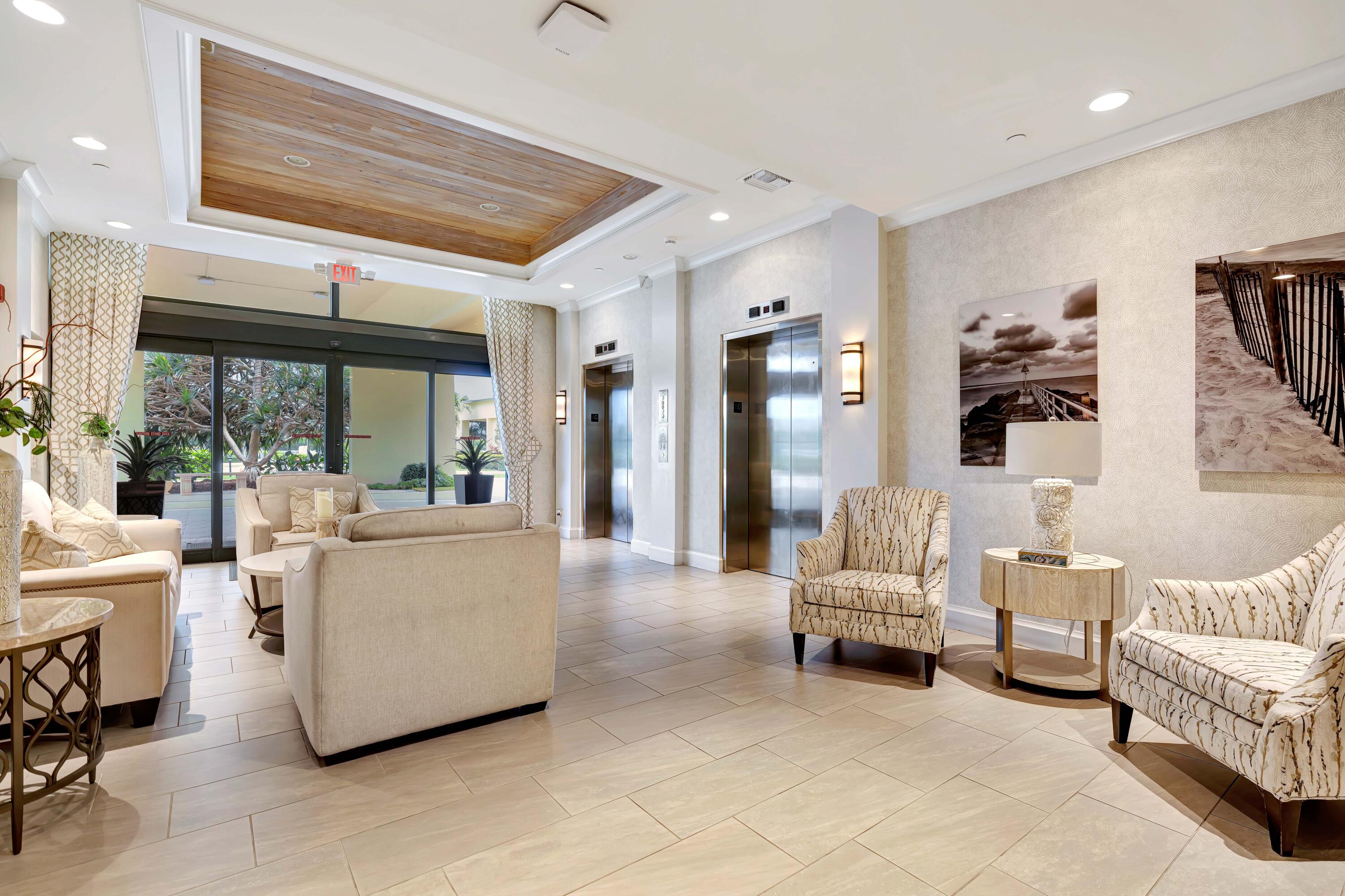 200 Ocean Trail Way, Unit 405 Jupiter, FL 33477 - Photo 42 of 46 a living room with furniture and a large window