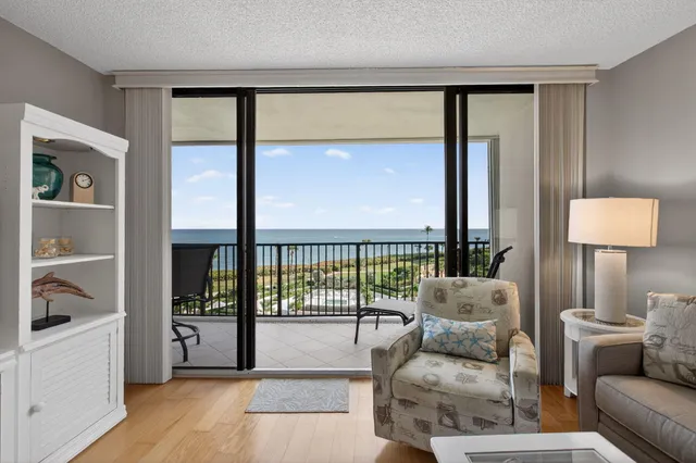 a living room with furniture and a floor to ceiling window
