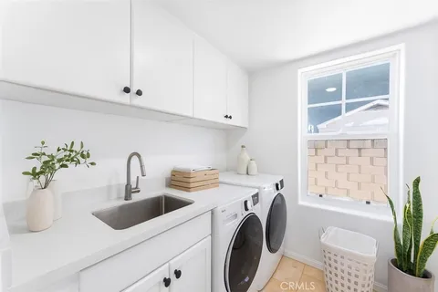a view of a hallway with wooden floor and a potted plant