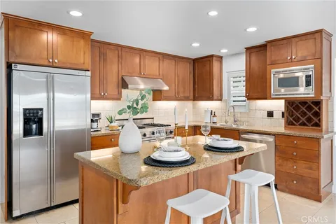 a kitchen with a sink refrigerator and cabinets