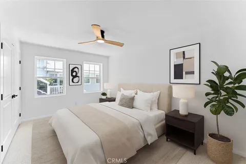 a bedroom with a large bed and a chandelier