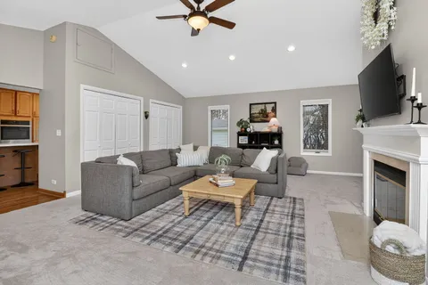 a living room with furniture a fireplace and a flat screen tv