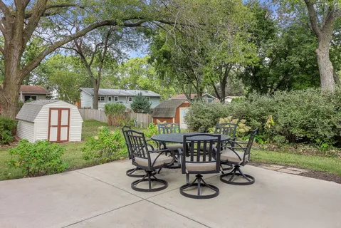 a view of an chairs and table in patio