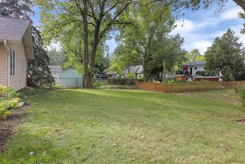 a backyard of a house with table and chairs