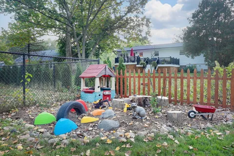 a view of a backyard with a table and chairs