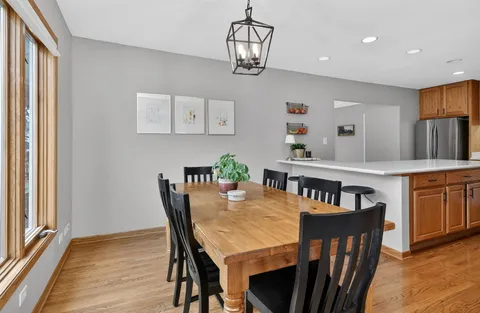 a view of a dining room with furniture and a chandelier