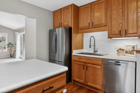 a kitchen with stainless steel appliances granite countertop a refrigerator sink and cabinets