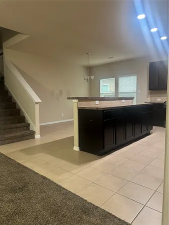 a kitchen with a cabinets and chandelier