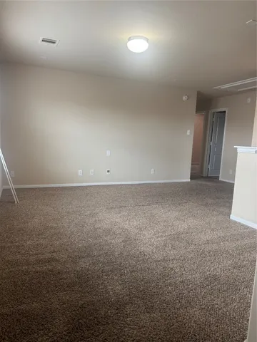 an empty room with a empty space and windows