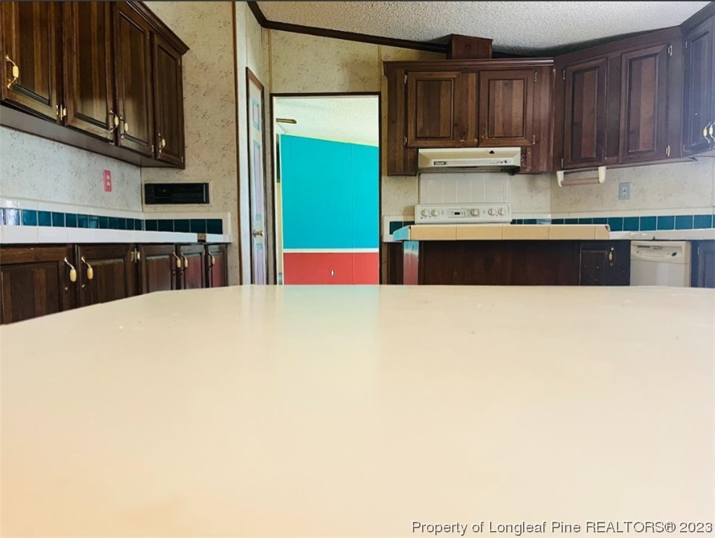 844 Boyd Lake Road Hamlet, NC 28345 - Photo 6 of 21 a kitchen with stainless steel appliances a sink a stove and a microwave