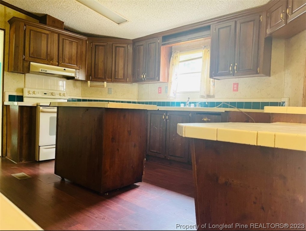 844 Boyd Lake Road Hamlet, NC 28345 - Photo 7 of 21 a kitchen with stainless steel appliances granite countertop a stove a sink and a microwave