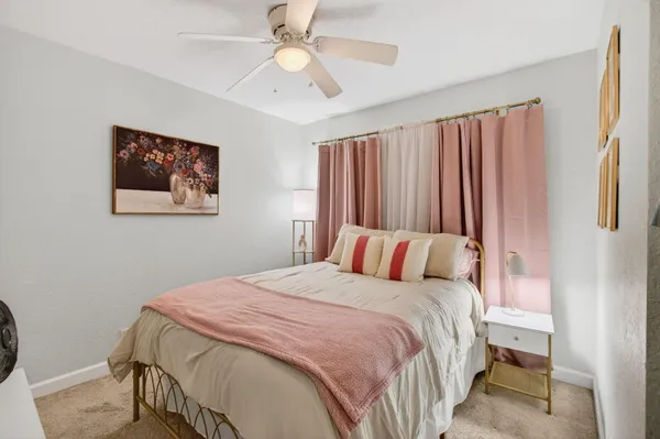 a bedroom with a large bed and a chandelier