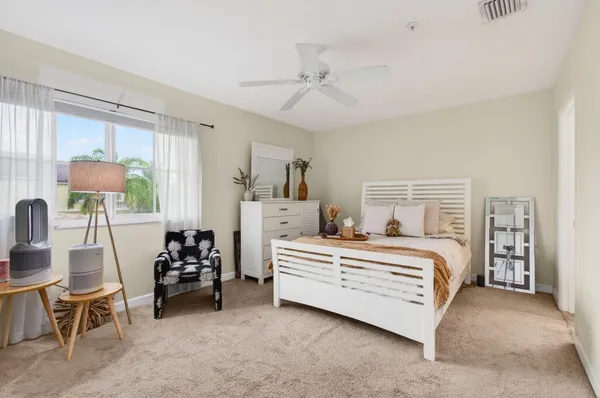 a spacious bedroom with a bed and a window