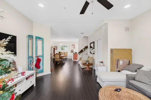 a living room with furniture and a wooden floor
