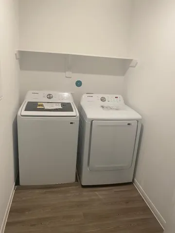 a view of a refrigerator in kitchen and a wooden floor