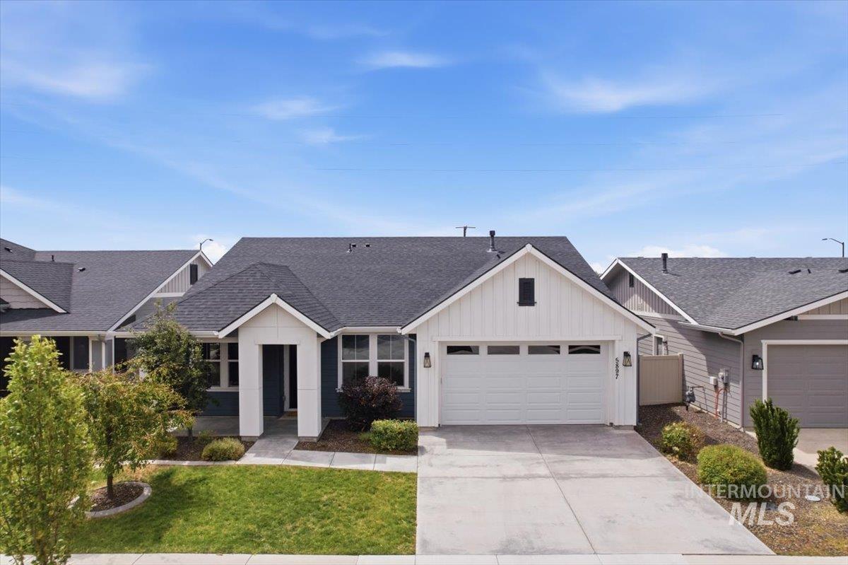 5897 West Riva Capri Street Meridian, ID 83646 - Photo 49 of 50 Contemporary single-story residence featuring a two-tone exterior, attached two-car garage, covered entry, front lawn, and concrete driveway