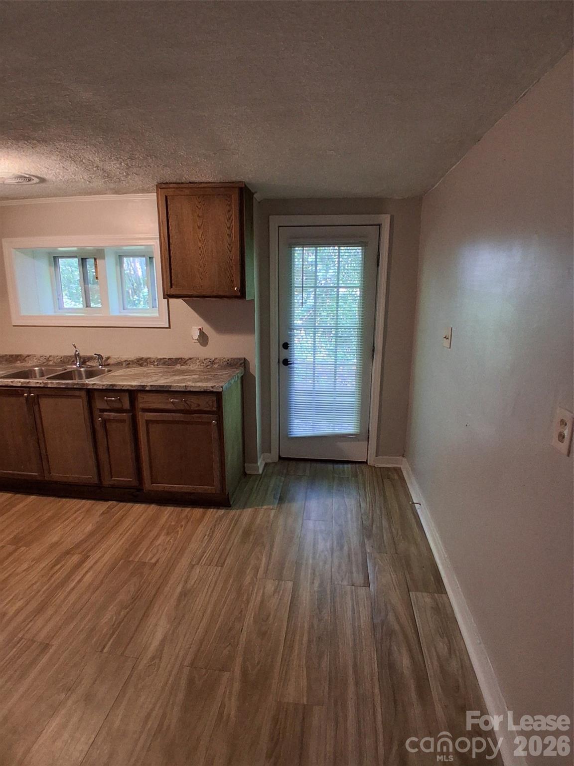 912 Berryhill Road Charlotte, NC 28208 - Photo 11 of 15 an empty room with wooden floor and windows