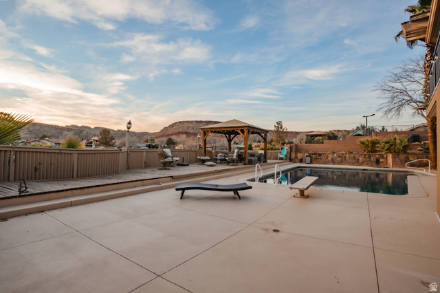 980 Cactus Circle St. George, UT 84790 - Photo 58 of 77 View of pool with a mountain view, patio surround, a gazebo, and a fenced backyard