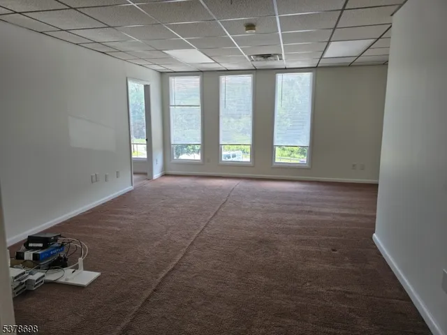 an empty room with windows and outdoor space