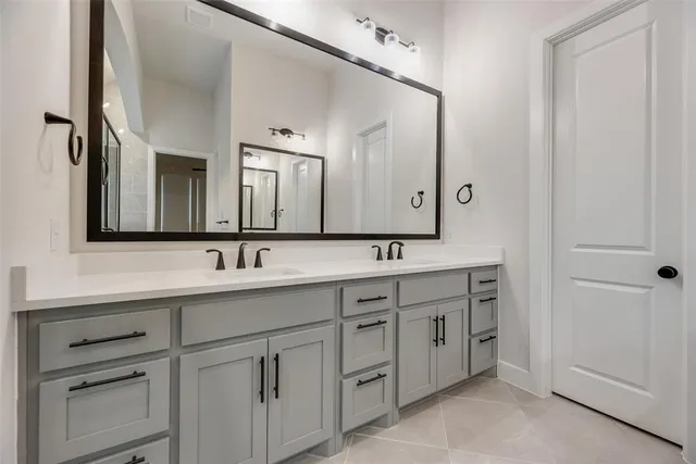 a bathroom with a double vanity sink and mirror