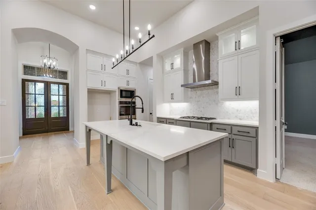 a kitchen with stainless steel appliances a sink stove and refrigerator