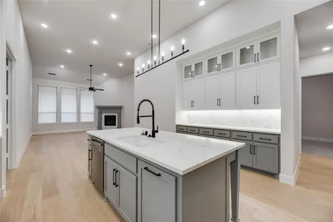 a kitchen with a stove a sink and a refrigerator