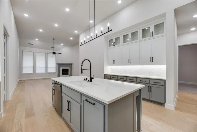 a kitchen with a stove a sink and a refrigerator