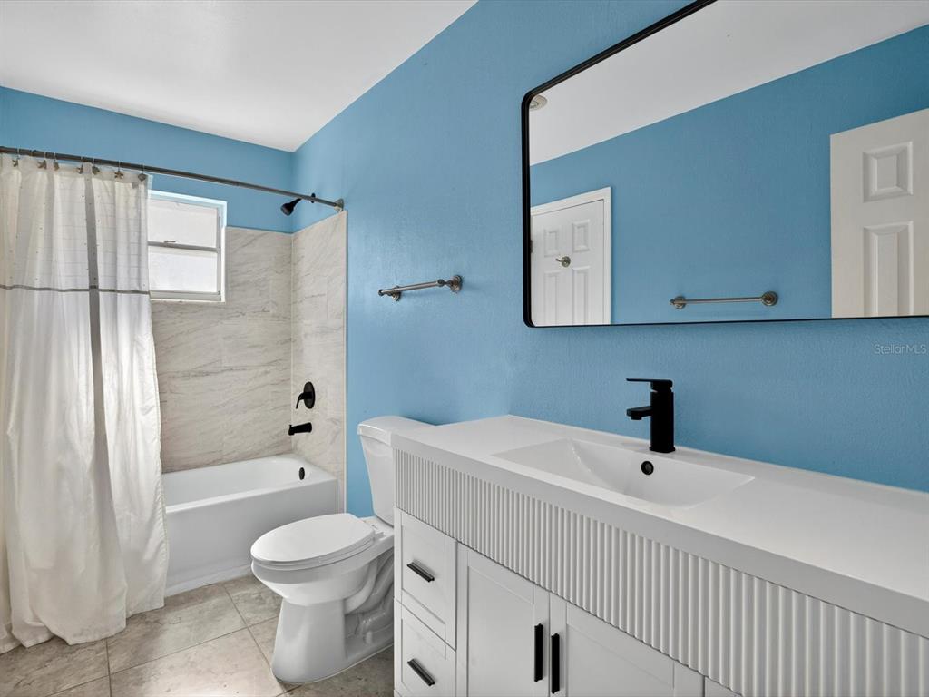 11321 Scenic View Lane Orlando, FL 32821 - Photo 11 of 29 a bathroom with a sink a toilet and shower