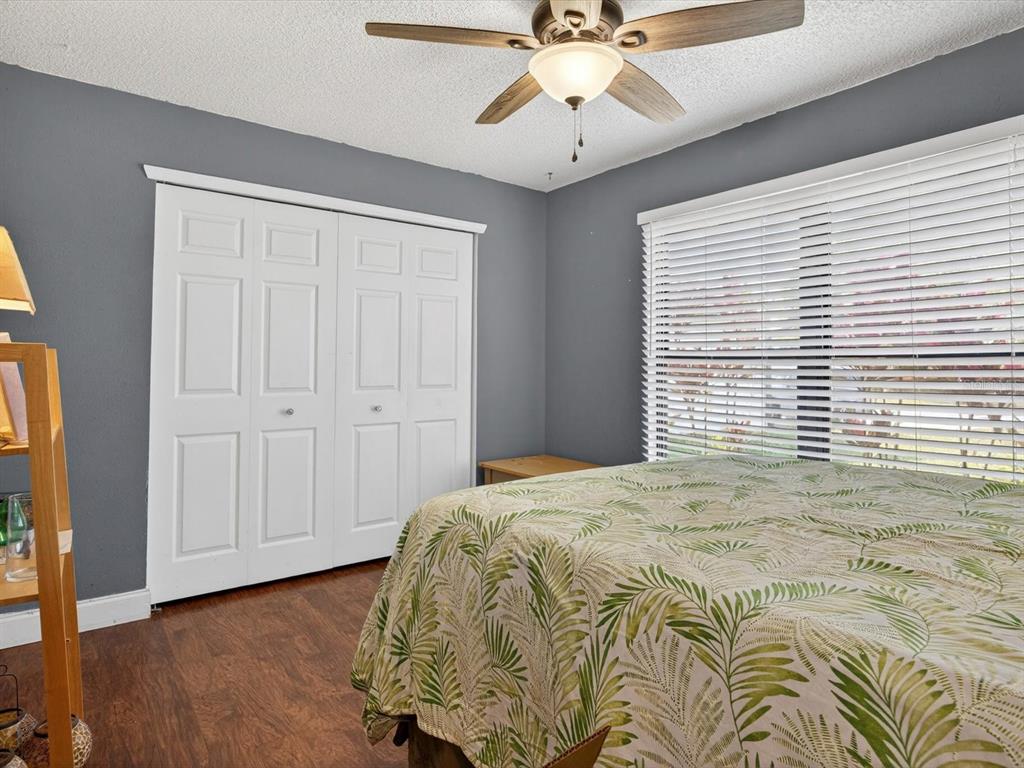11321 Scenic View Lane Orlando, FL 32821 - Photo 12 of 29 a view of a bedroom with wooden floor and windows