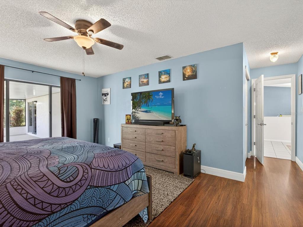 11321 Scenic View Lane Orlando, FL 32821 - Photo 14 of 29 a bedroom with a bed and a chandelier