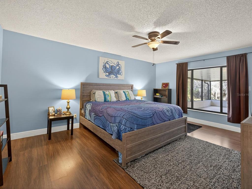 11321 Scenic View Lane Orlando, FL 32821 - Photo 15 of 29 a bedroom with a bed and a chandelier